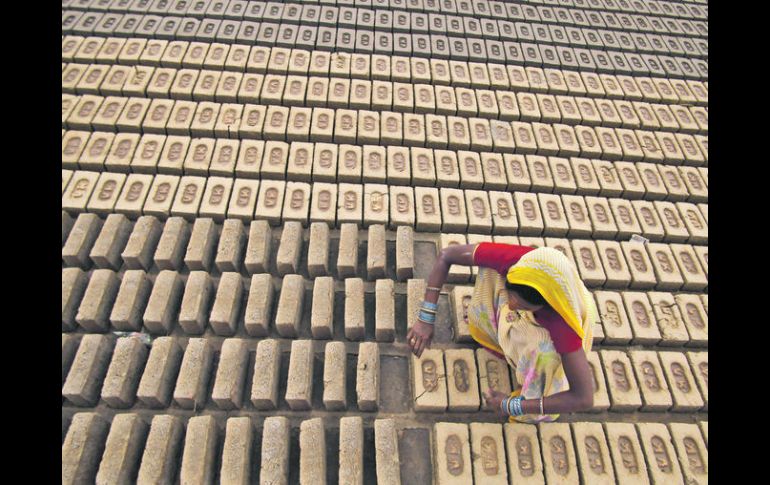 Una mujer trabaja en una fábrica de ladrillos y construcción en Jamu (India), un empleo poco común para mujeres. AP  /