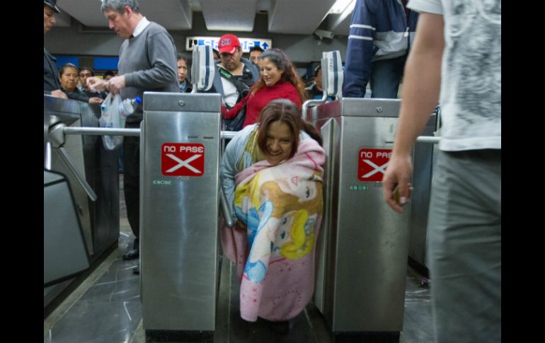 Una mujer ingresa al Metro de la Ciudad de México sin pagar la cuota por utilizar el servicio. NTX /