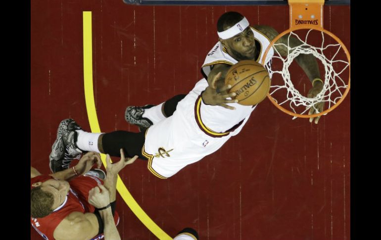 LeBron James clava el balón superando la marca de Blake Griffin. AP / T. Dejak