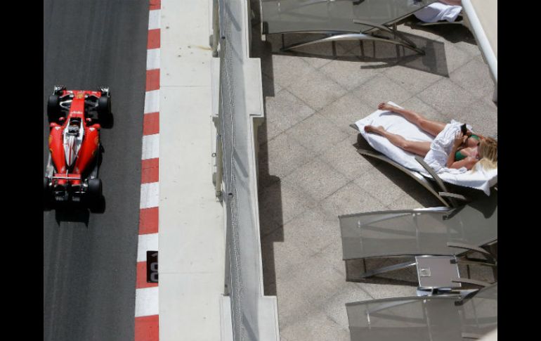Una mujer observa el auto de Vettel durante la sesión de entrenamiento. AP / C. Paris