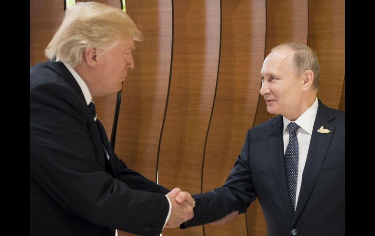 Mientras asesores tomaban sus asientos en torno a una amplia mesa, Trump le dio la mano a Putin y ambos sonrieron. EFE / S. Kuggler